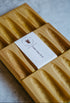 Three cedar soap decks, the middle one with a label.