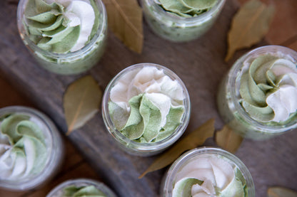 arial view of open jars of tobacco and bay leaf sugar whipped soap