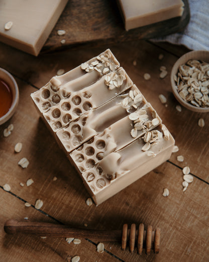 Oatmeal milk and honey goat milk soap bars. Tan soap with textured top with oats. Top view. 